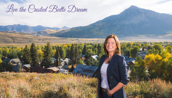 snow-covered homes and condos in Crested Butte CO with mountains in the background